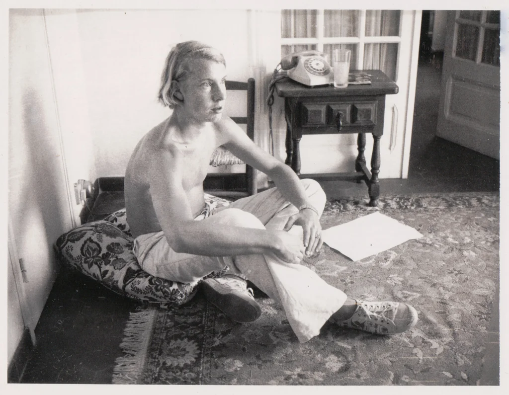 Photograph of young man seated on floor for Serenade painting