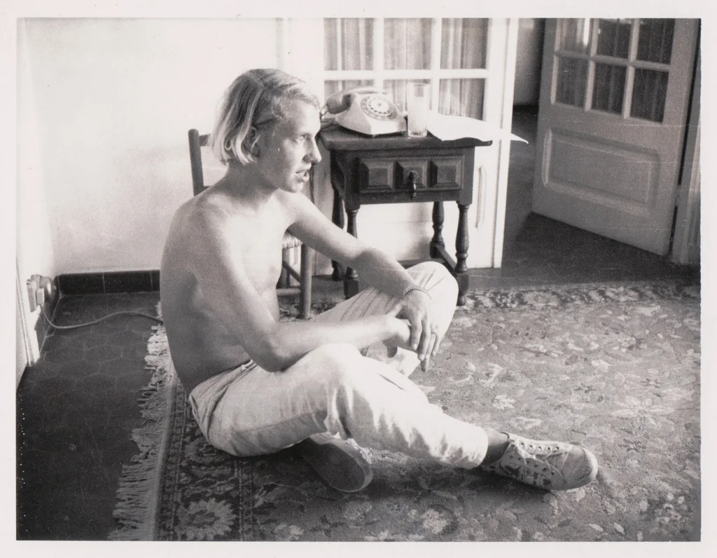 Photograph of young man seated on floor for Serenade painting