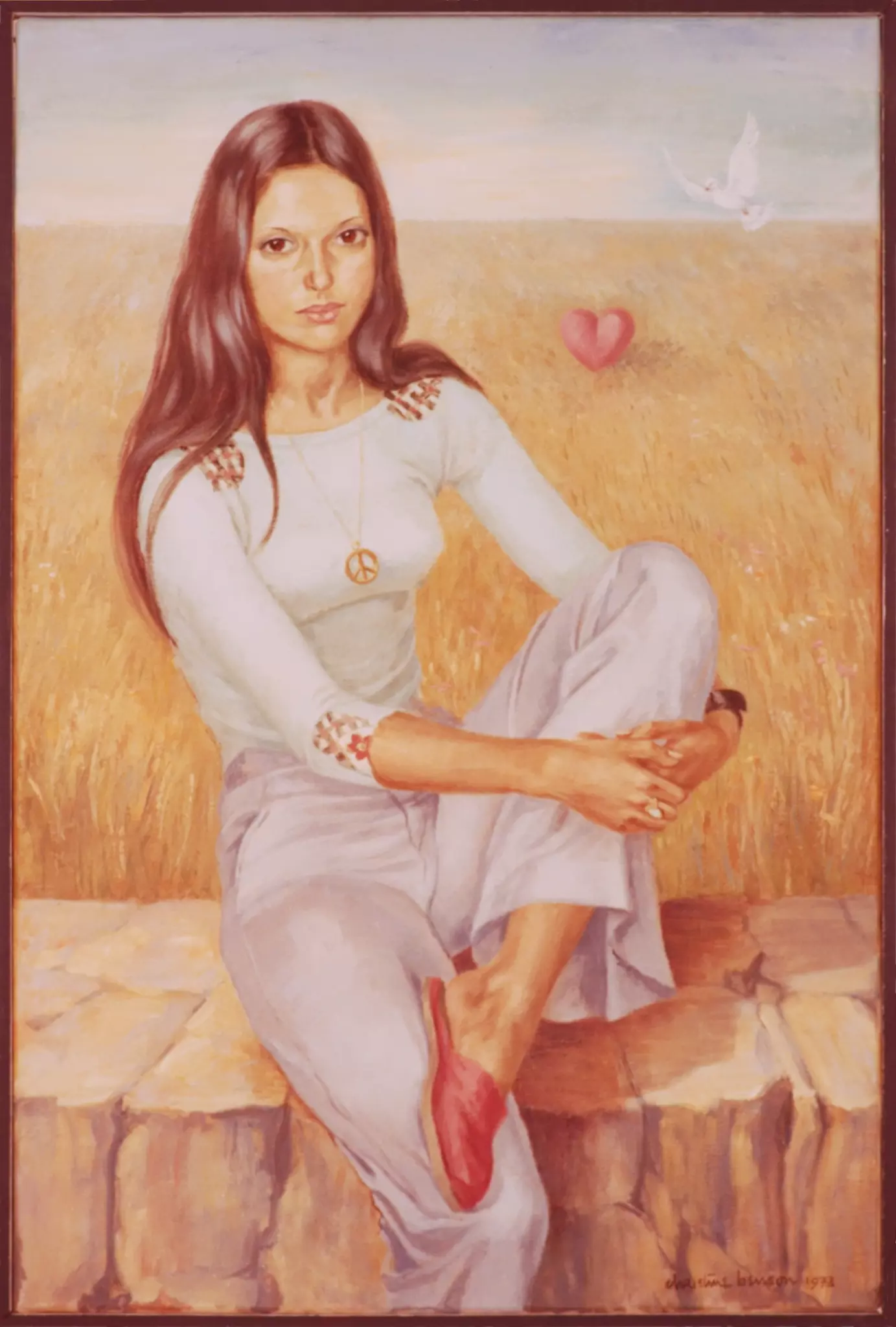 Portrait of young woman sitting on a wall