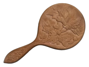 a carved wooden hand mirror